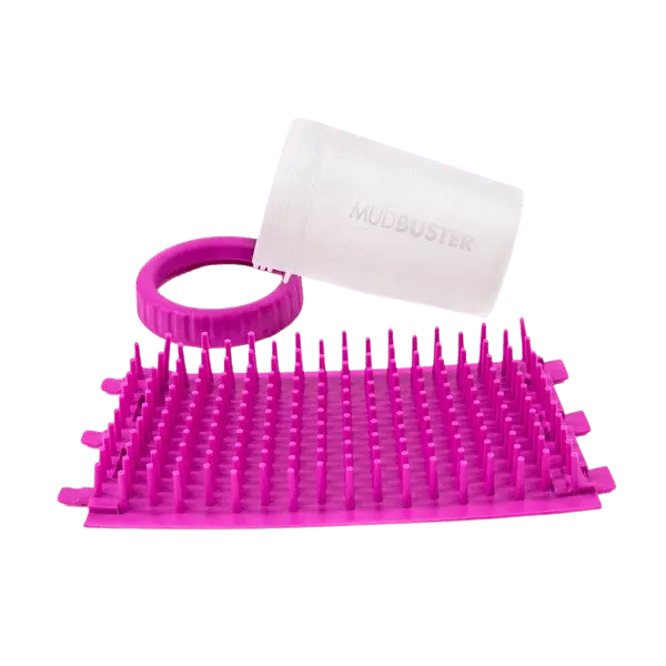 Disassembled Dexas Mudbuster in pink showing silicone bristles, lid, and container, ideal for cleaning muddy dog paws on-the-go.