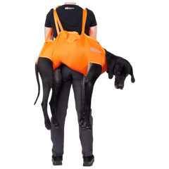 Person carrying a black dog in an orange Non-stop dogwear rescue sling - dog rescue sling